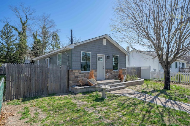 bungalow featuring stone siding and fence