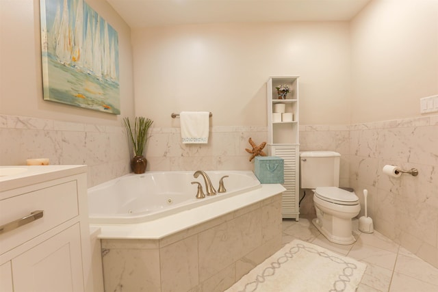 bathroom featuring vanity, toilet, tile walls, and tiled bath