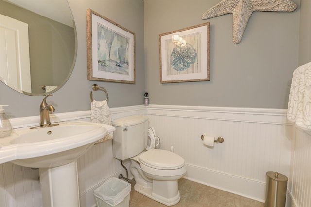 bathroom with tile patterned flooring, toilet, and sink