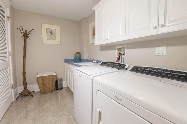 laundry room with washer and dryer, sink, and cabinets