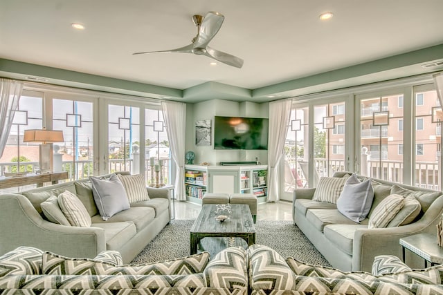 living room with ceiling fan and a healthy amount of sunlight