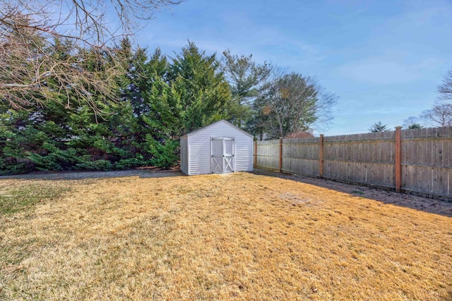 view of yard featuring an outbuilding, fence, and a shed