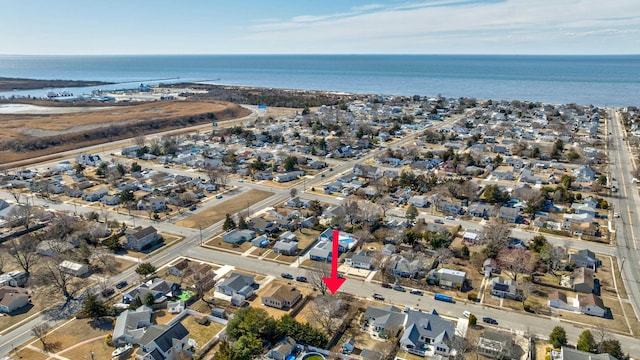 drone / aerial view with a residential view and a water view