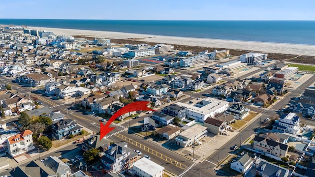 bird's eye view featuring a water view and a beach view