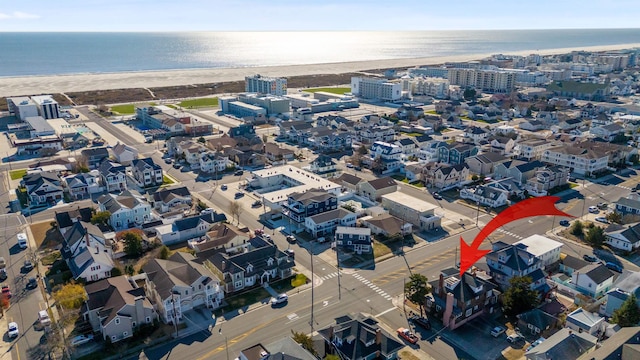 aerial view with a water view and a view of the beach