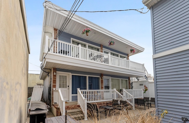 view of front facade featuring a balcony and covered porch