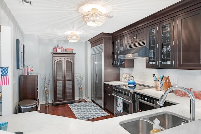 9601 Atlantic Ave Unit 310, Lower Township, NJ 08260 - kitchen featuring high quality appliances, a sink, exhaust hood, dark brown cabinetry, and decorative backsplash