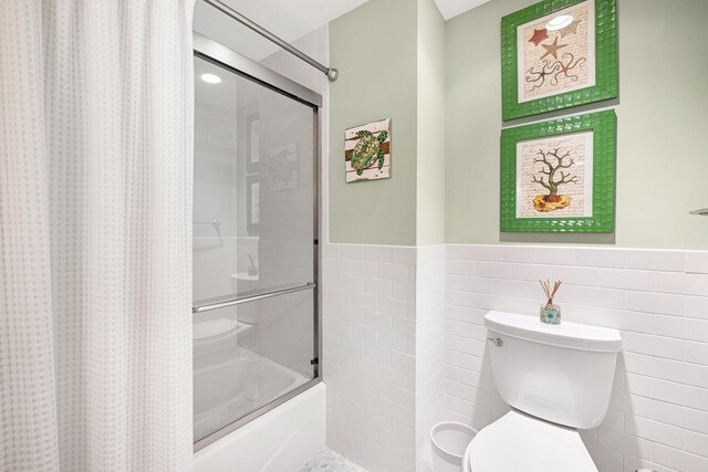9601 Atlantic Ave Unit 310, Lower Township, NJ 08260 - full bath featuring tile walls, shower / bath combination with curtain, wainscoting, and toilet