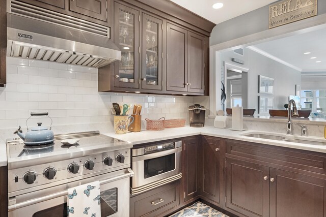 9601 Atlantic Ave Unit 310, Lower Township, NJ 08260 - kitchen with exhaust hood, high end stainless steel range oven, a sink, dark brown cabinets, and crown molding