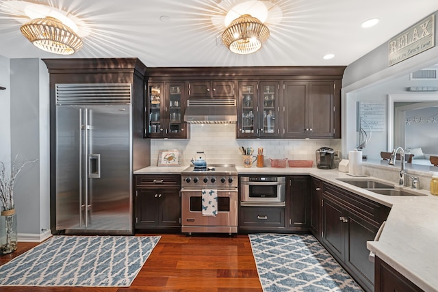9601 Atlantic Ave Unit 310, Lower Township, NJ 08260 - kitchen featuring high end appliances, ventilation hood, a sink, light countertops, and dark wood-style flooring
