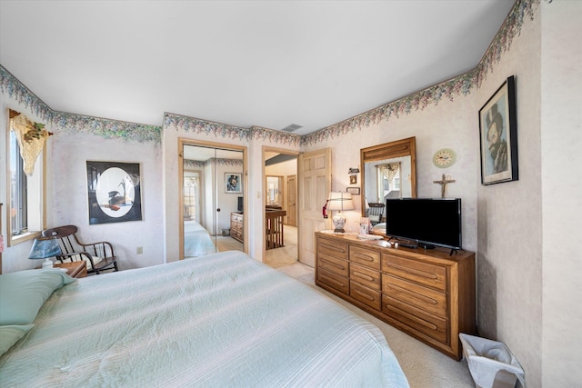 bedroom featuring light carpet