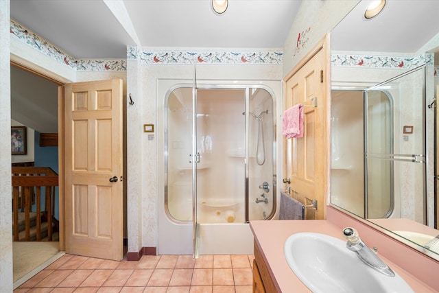 bathroom featuring tile patterned floors, vanity, and enclosed tub / shower combo