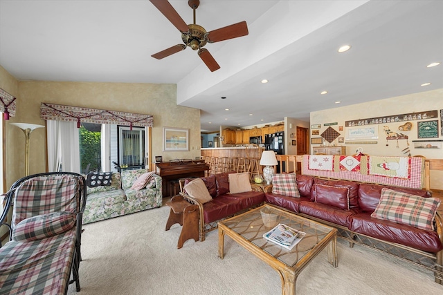 carpeted living room with ceiling fan and lofted ceiling