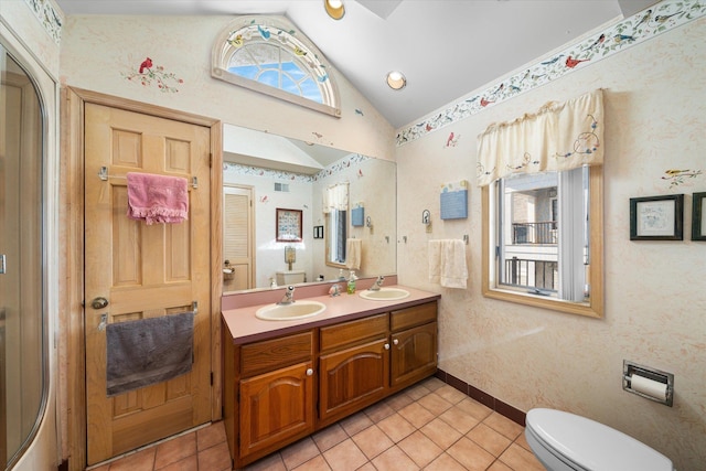 bathroom featuring tile patterned floors, vanity, vaulted ceiling, and toilet