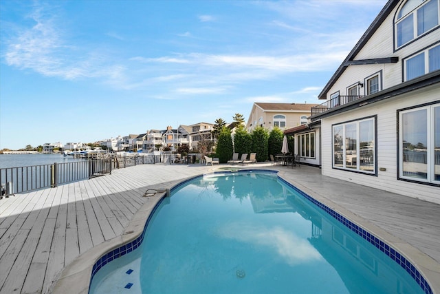 view of swimming pool with a deck with water view