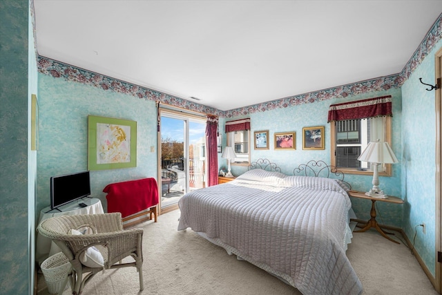 bedroom featuring access to exterior and carpet floors