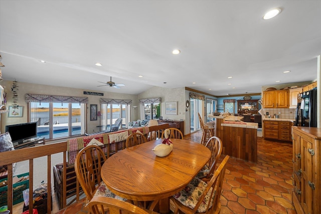 dining space with vaulted ceiling and ceiling fan