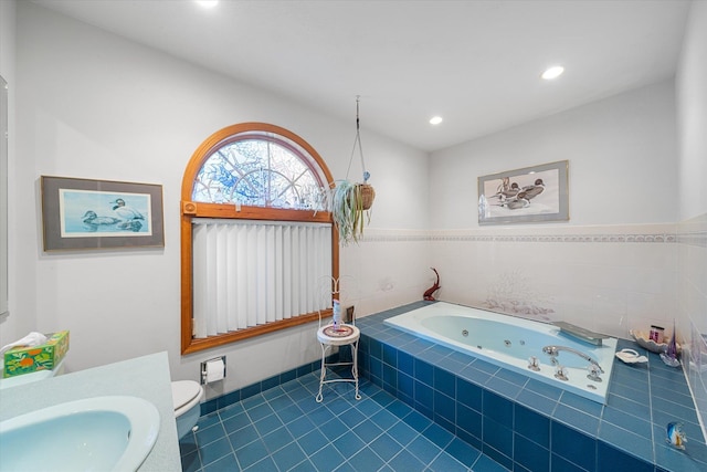 bathroom with toilet, tile patterned flooring, a relaxing tiled tub, and sink