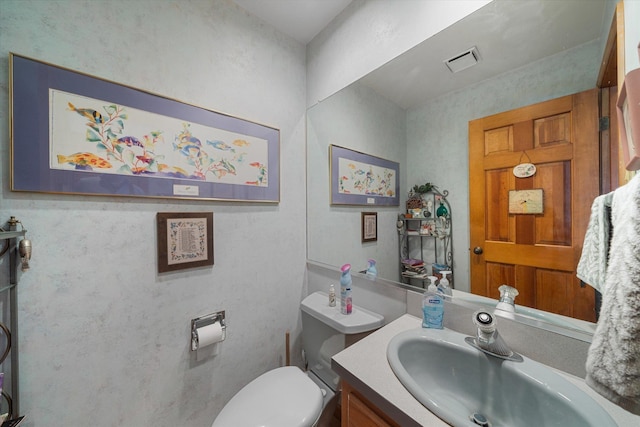 bathroom with vanity and toilet