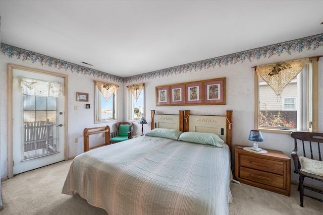 carpeted bedroom featuring access to exterior