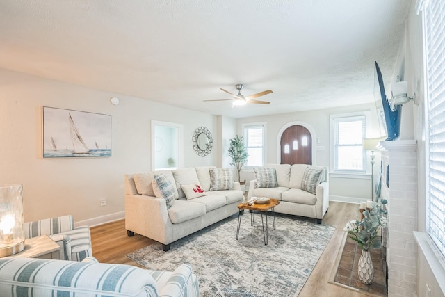 6110 Seaview Ave, Wildwood Crest, NJ 08260 - living area with wood finished floors, a ceiling fan, and a fireplace