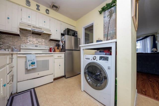 kitchen with visible vents, washer / clothes dryer, freestanding refrigerator, electric stove, and under cabinet range hood