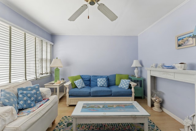 living room with ornamental molding, ceiling fan, and light wood-type flooring