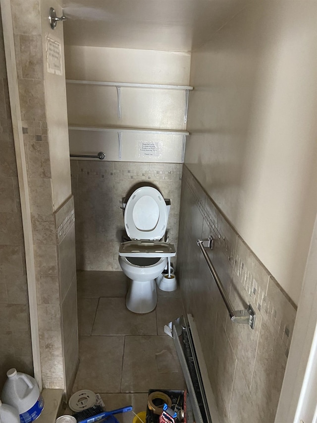 bathroom with tile walls, toilet, and tile patterned flooring