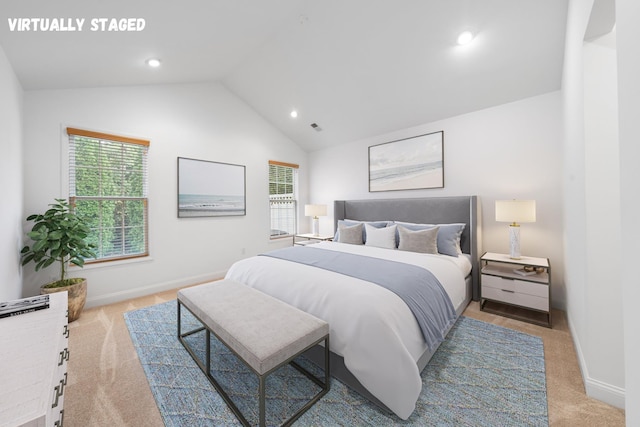 bedroom featuring light carpet and vaulted ceiling