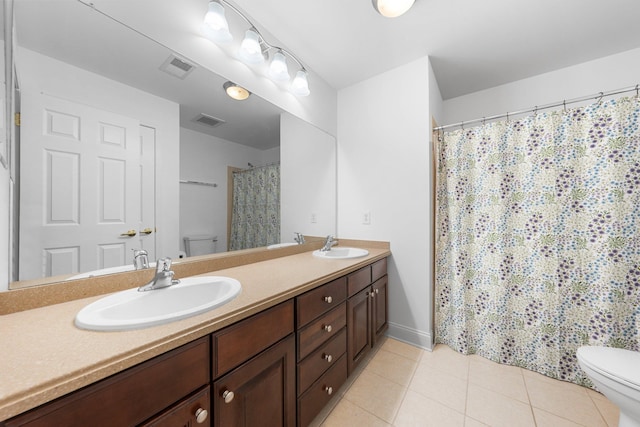 bathroom with tile patterned floors, vanity, and toilet