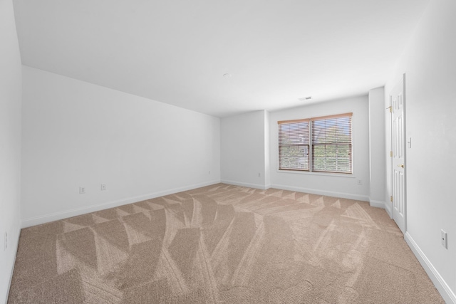 empty room with light colored carpet