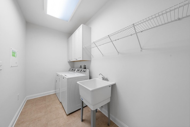 laundry room with cabinets and washing machine and clothes dryer