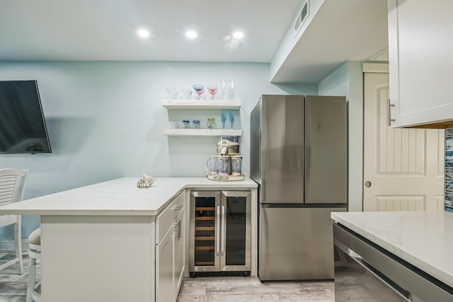 405 Ocean Ave Unit 110, North Wildwood, NJ 08260 - indoor dry bar with beverage cooler, freestanding refrigerator, light wood-type flooring, and recessed lighting