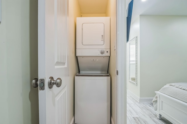 405 Ocean Ave Unit 110, North Wildwood, NJ 08260 - washroom with stacked washer and clothes dryer and wood finished floors