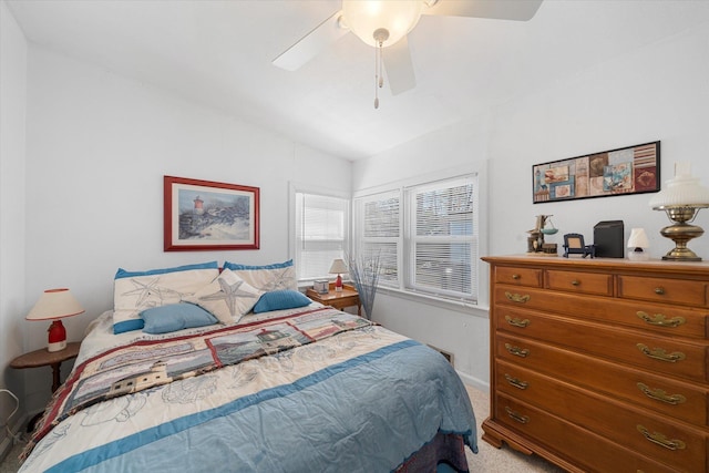 carpeted bedroom with ceiling fan and lofted ceiling