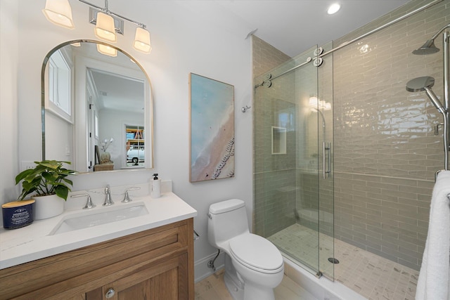 bathroom featuring toilet, vanity, and walk in shower