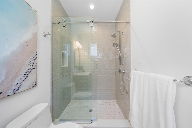 bathroom featuring an enclosed shower and toilet