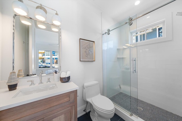 bathroom with walk in shower, a healthy amount of sunlight, toilet, and vanity