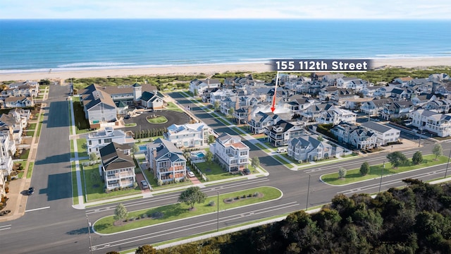 birds eye view of property featuring a view of the beach and a water view