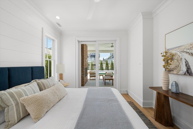 bedroom featuring ornamental molding, access to exterior, and light hardwood / wood-style floors