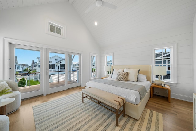 bedroom featuring access to exterior, high vaulted ceiling, ceiling fan, and light wood-type flooring