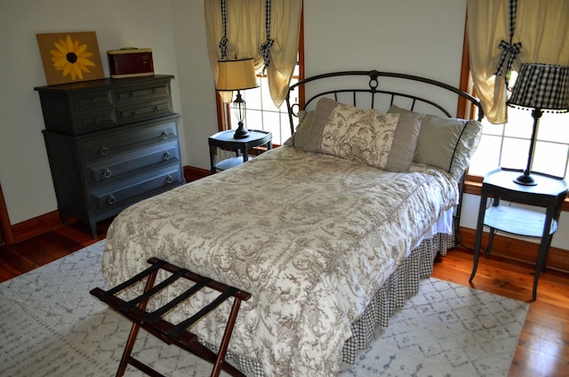 bedroom featuring multiple windows and hardwood / wood-style floors