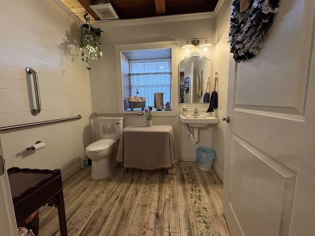 bathroom with sink, hardwood / wood-style floors, ornamental molding, and toilet