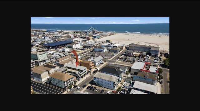 aerial view featuring a water view, a beach view, and a city view