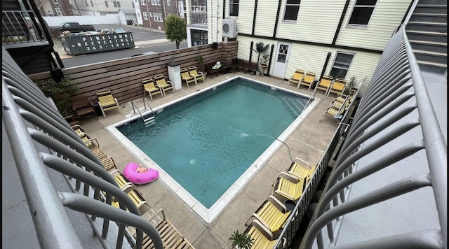 pool featuring a patio and fence