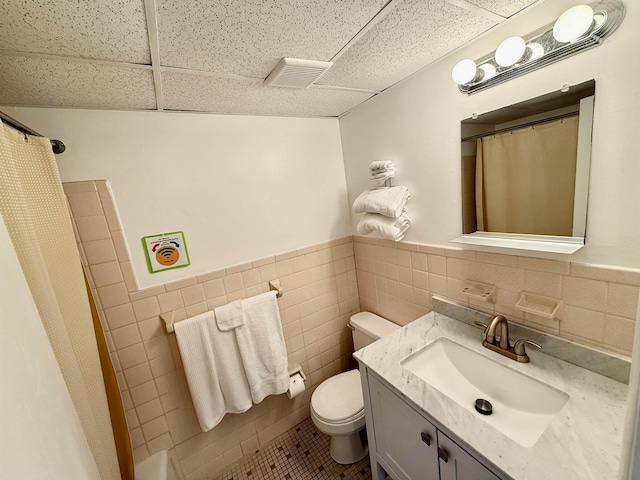 bathroom featuring visible vents, vanity, a paneled ceiling, and tile patterned floors