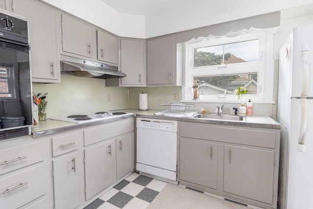 kitchen featuring white appliances, gray cabinetry, and sink