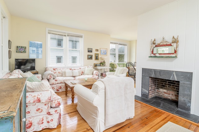 living room with hardwood / wood-style flooring and a fireplace