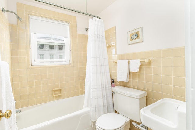 full bathroom with toilet, shower / bath combination with curtain, sink, and tile walls