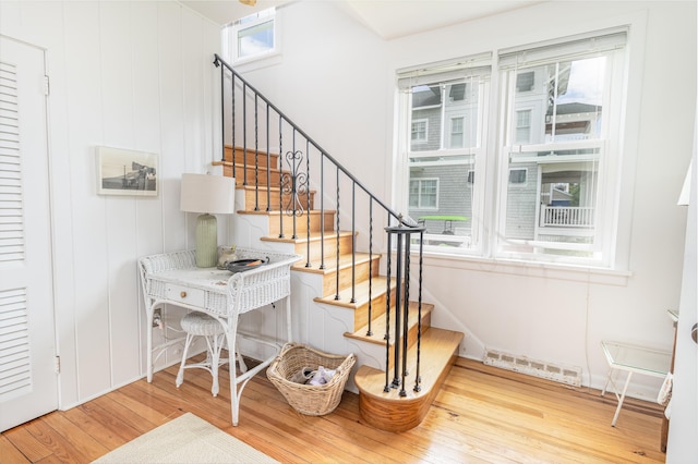 staircase featuring hardwood / wood-style floors and a healthy amount of sunlight